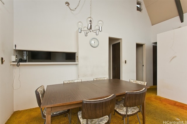 dining space with carpet, high vaulted ceiling, and an inviting chandelier