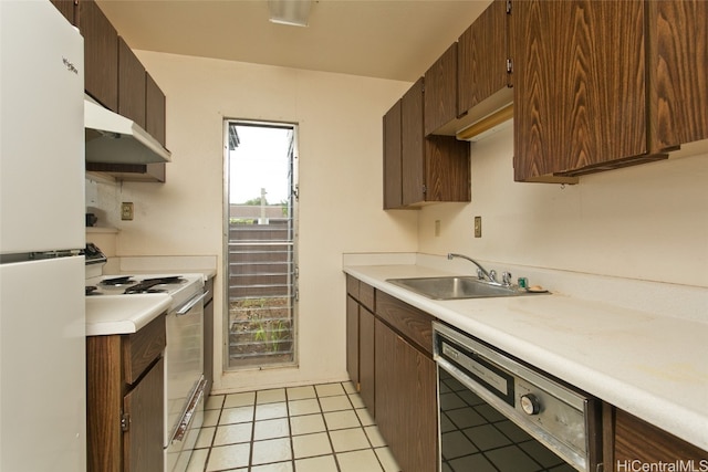 kitchen with light tile patterned flooring, dark brown cabinetry, white appliances, and sink