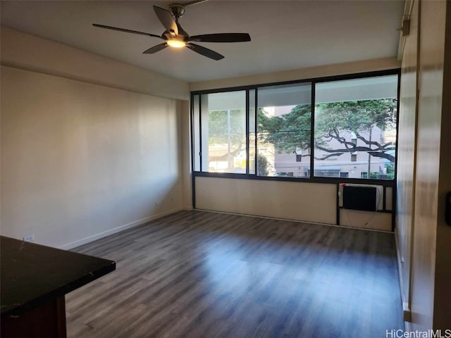 unfurnished room featuring ceiling fan and dark wood-type flooring