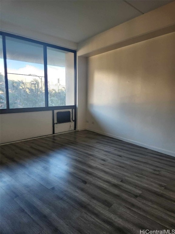 spare room with dark hardwood / wood-style floors