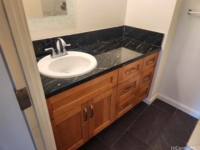 bathroom featuring tasteful backsplash, tile patterned flooring, and vanity