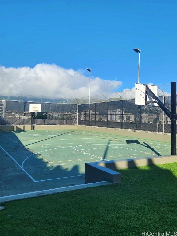 view of sport court featuring a lawn