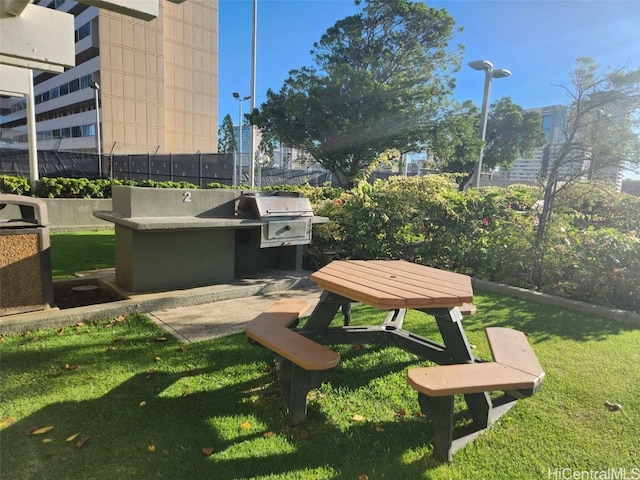 view of property's community with a patio, a yard, and area for grilling