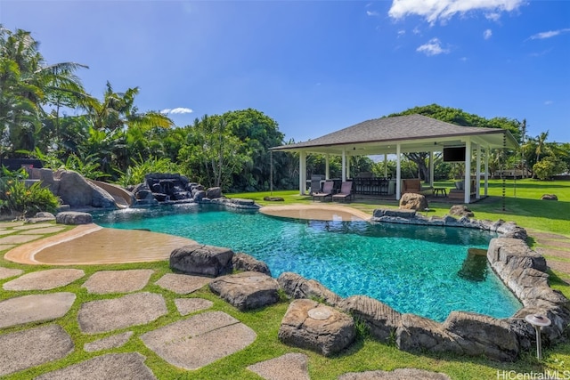 view of swimming pool with a gazebo, pool water feature, a lawn, and a patio