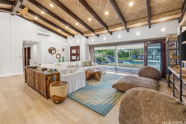 living room featuring beamed ceiling, a wall unit AC, high vaulted ceiling, and light hardwood / wood-style flooring