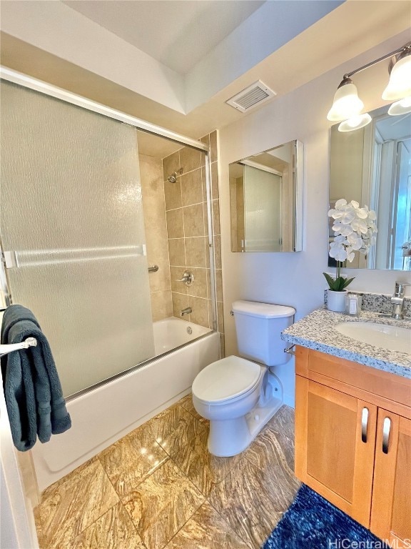 full bathroom featuring combined bath / shower with glass door, vanity, and toilet