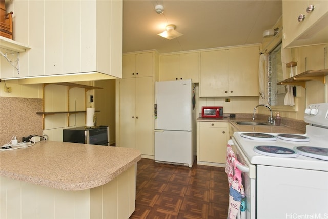 kitchen with sink, dark parquet flooring, white appliances, and kitchen peninsula