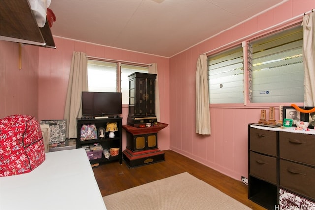 bedroom with dark hardwood / wood-style floors