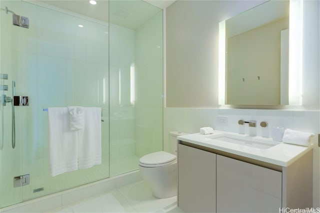 bathroom featuring walk in shower, vanity, tile walls, tile patterned flooring, and toilet