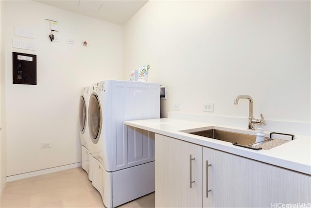 laundry room featuring sink, cabinets, and independent washer and dryer