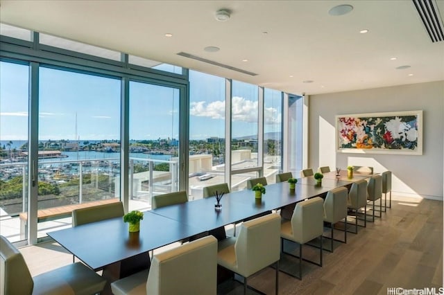 dining room featuring hardwood / wood-style floors and expansive windows