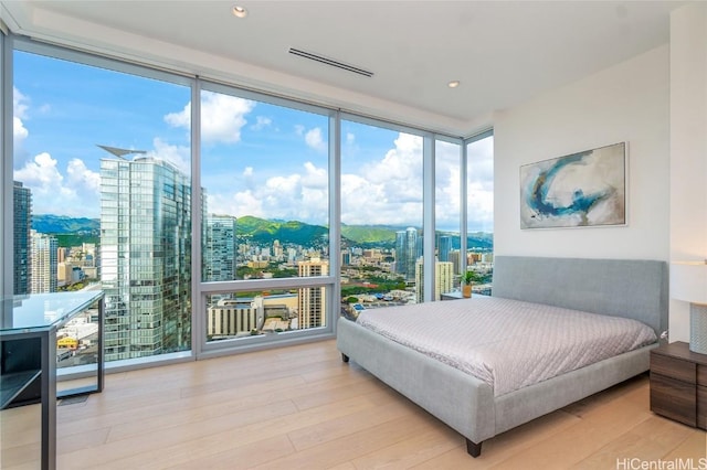 bedroom featuring light hardwood / wood-style flooring and floor to ceiling windows