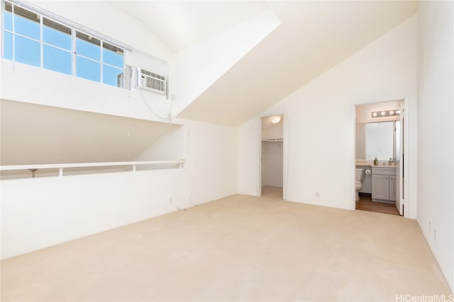 additional living space featuring carpet, lofted ceiling, and an AC wall unit