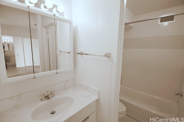 full bathroom with vanity, toilet, and tiled shower / bath