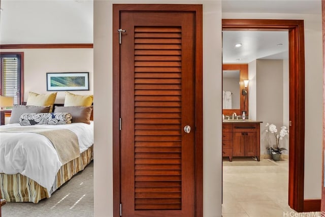 bedroom featuring a sink and connected bathroom