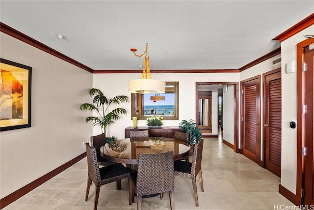 dining room featuring crown molding and baseboards