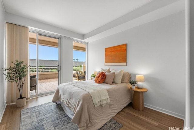 bedroom with access to exterior and wood-type flooring