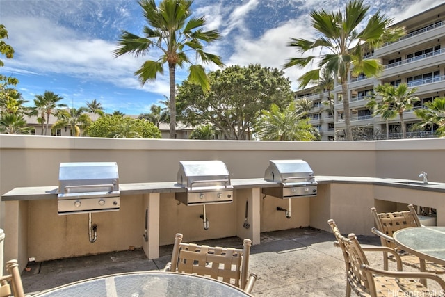 view of patio / terrace with area for grilling, sink, and exterior kitchen