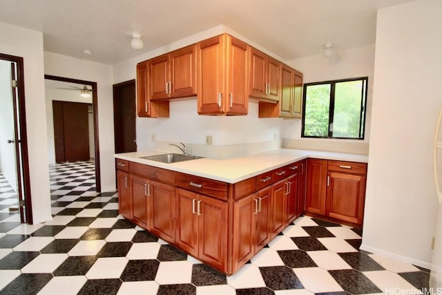 kitchen featuring ceiling fan and sink