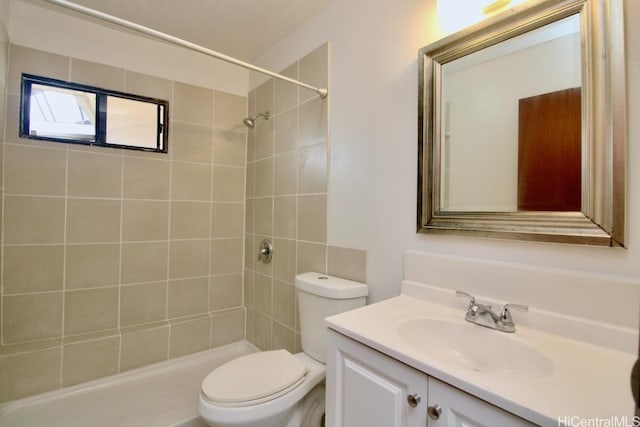 bathroom featuring toilet, vanity, and tiled shower