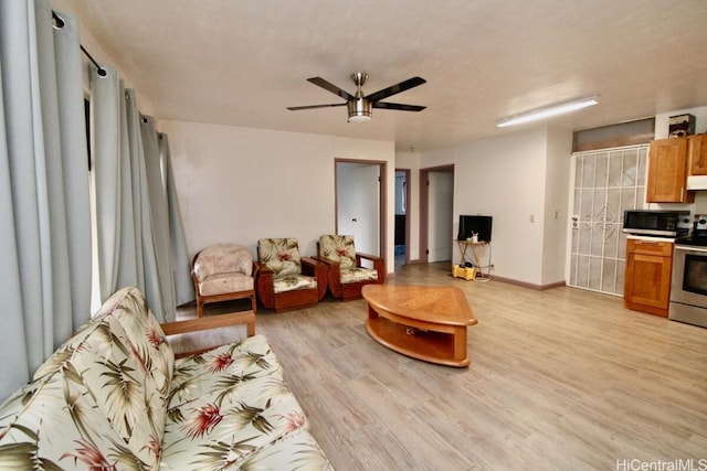 living room featuring light hardwood / wood-style floors and ceiling fan