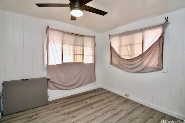 empty room featuring hardwood / wood-style floors and ceiling fan