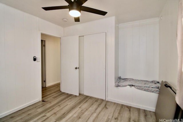 bedroom featuring ceiling fan, light hardwood / wood-style floors, and a closet