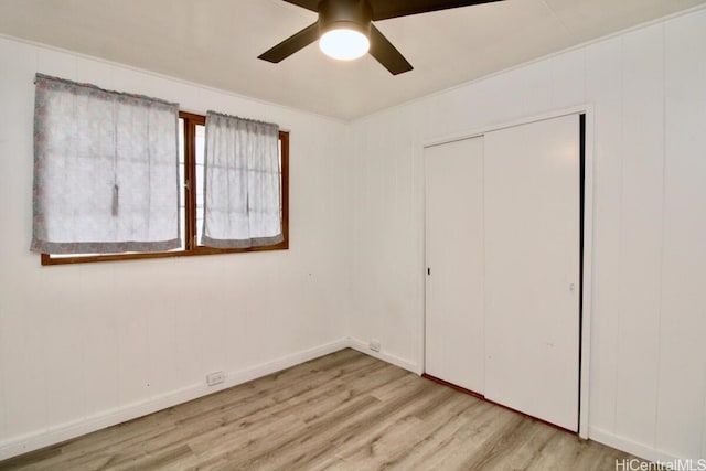 unfurnished bedroom featuring a closet, ceiling fan, light hardwood / wood-style flooring, and ornamental molding