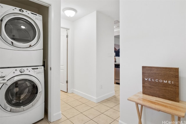 washroom featuring light tile patterned flooring and stacked washer and clothes dryer