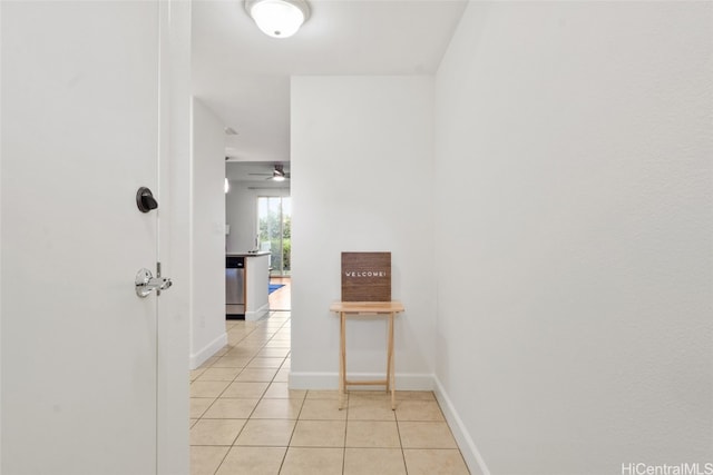 hall featuring light tile patterned floors