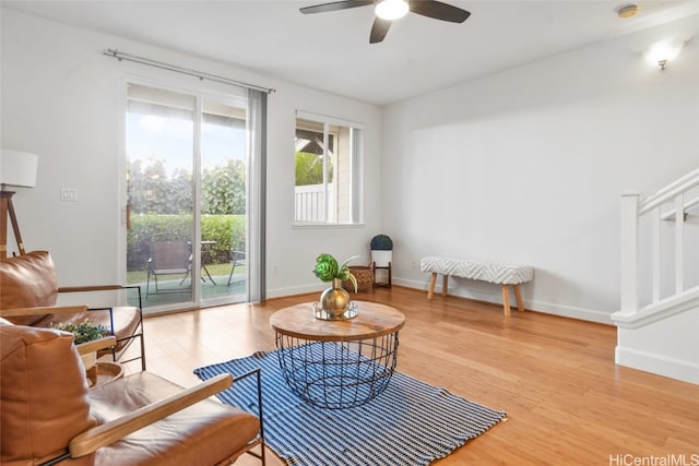 living area featuring ceiling fan and hardwood / wood-style floors