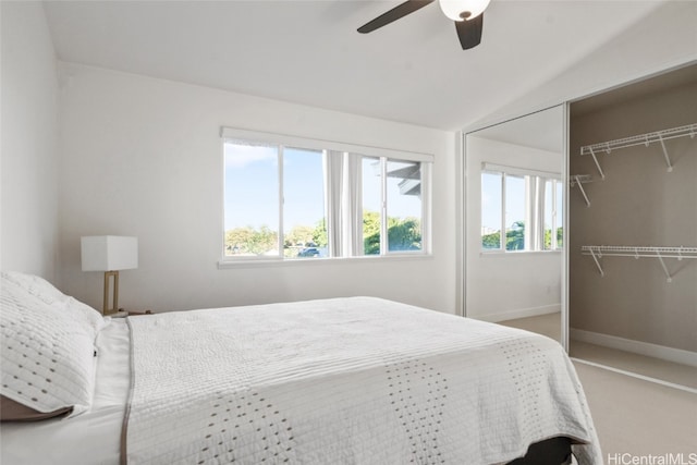 carpeted bedroom featuring ceiling fan, a closet, and lofted ceiling