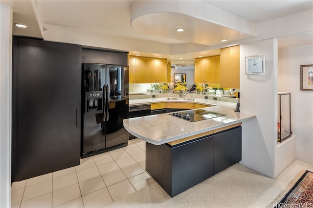 kitchen featuring light brown cabinets, black appliances, sink, light tile patterned floors, and kitchen peninsula