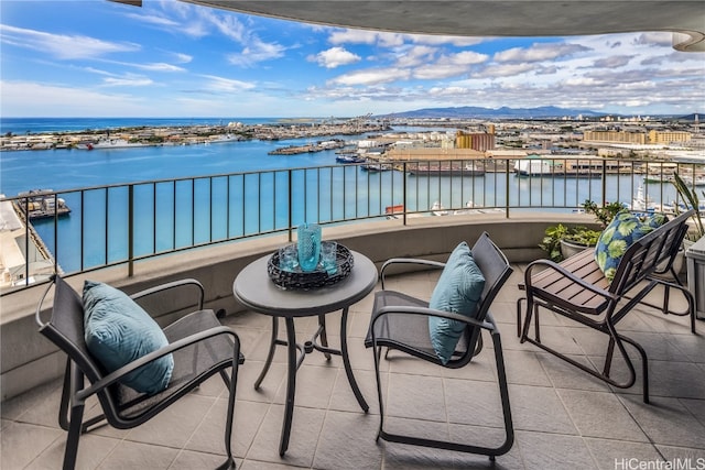 balcony featuring a water and mountain view