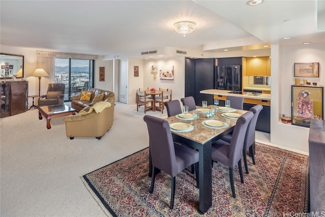 dining space with carpet flooring