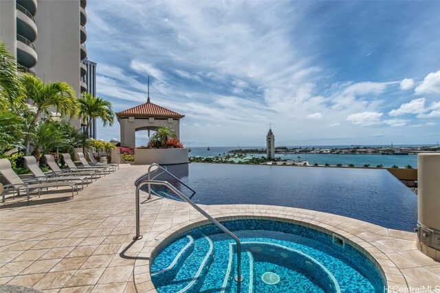 view of pool with a community hot tub, a water view, and a gazebo