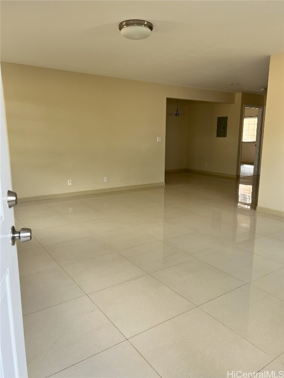 tiled empty room with electric panel