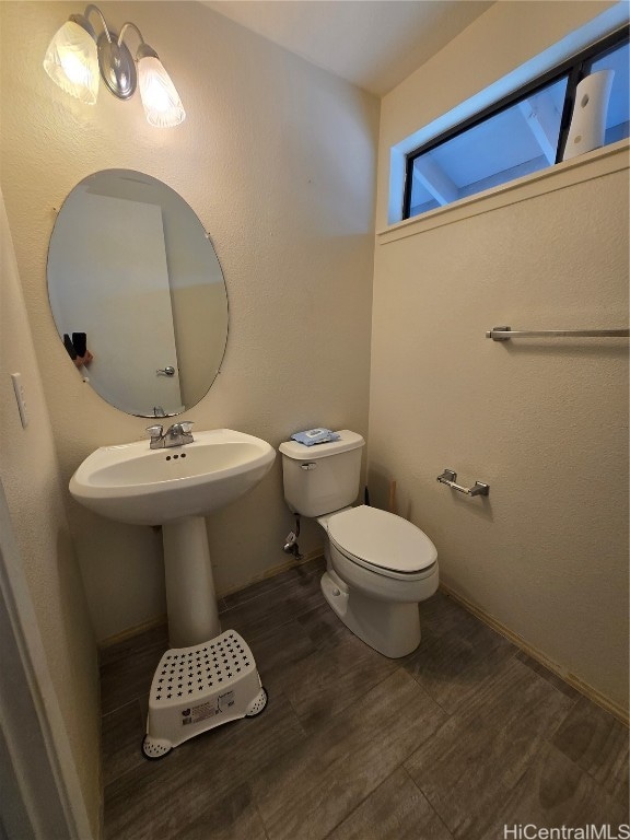 bathroom with hardwood / wood-style floors and toilet