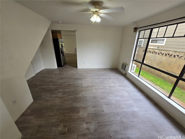 spare room with ceiling fan and a wall mounted air conditioner