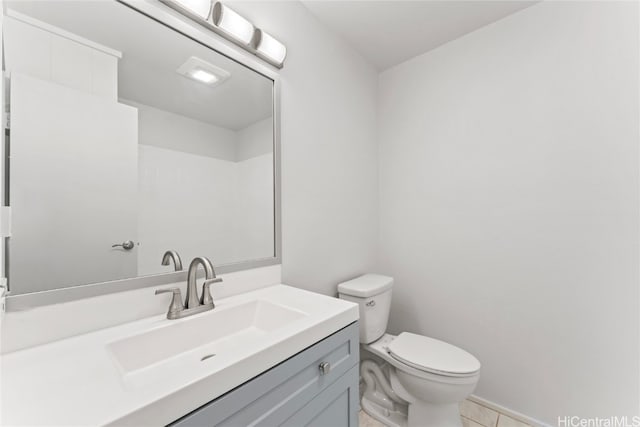 bathroom featuring tile patterned floors, vanity, and toilet