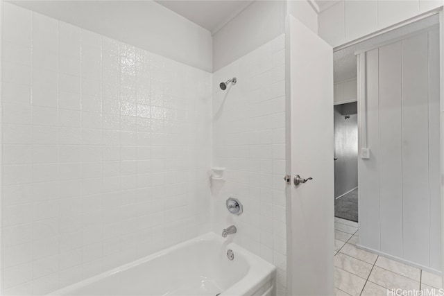 bathroom featuring tile patterned floors and tiled shower / bath