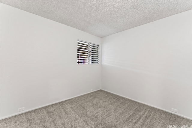 carpeted empty room with a textured ceiling