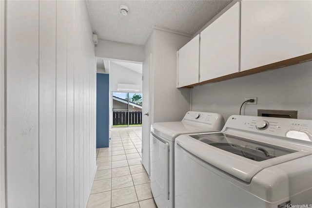 98-519 Lulu Pl Unit 73, Aiea, HI 96701 - laundry area with cabinet space, washing machine and dryer, a textured ceiling, and wood walls