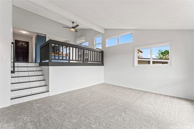 unfurnished living room with lofted ceiling with beams, carpet flooring, ceiling fan, a textured ceiling, and a wall unit AC