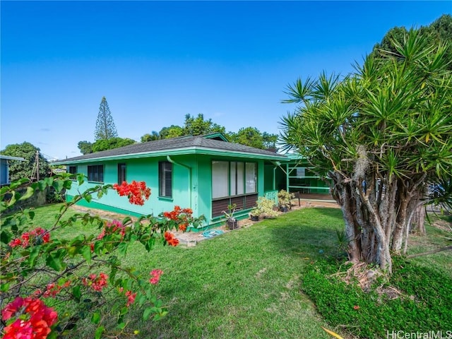 rear view of property featuring a yard