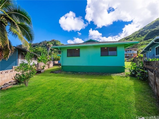 rear view of property featuring a yard