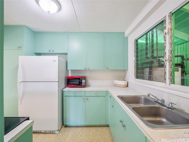 kitchen featuring sink and white fridge