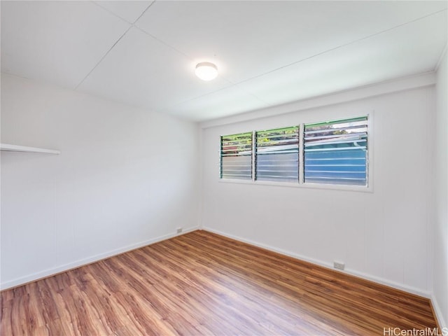 unfurnished room with wood-type flooring