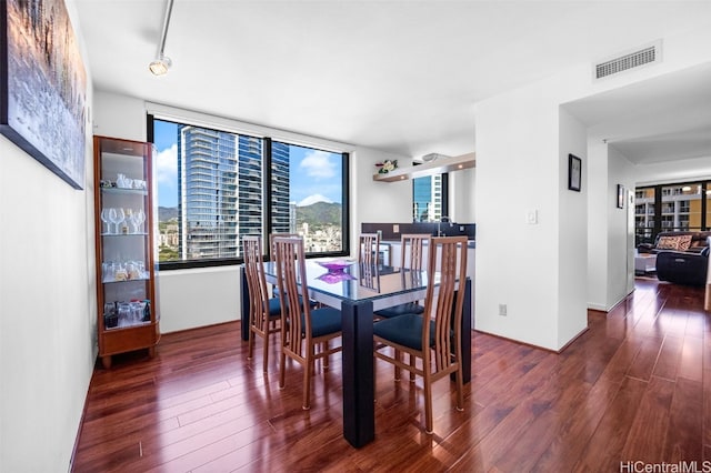 dining space featuring wood finished floors and visible vents