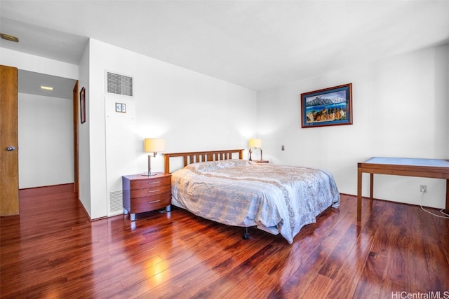 bedroom with visible vents and wood finished floors